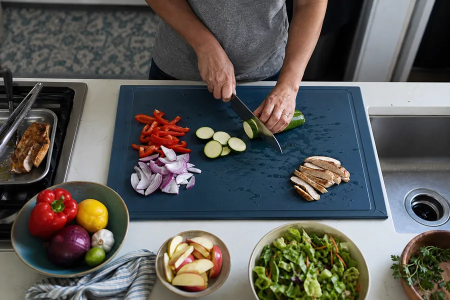 daily meal preppers comparing large cutting board non slip for a board needs to handle vegetables, fruit, and cooked food without sliding across a small counter.