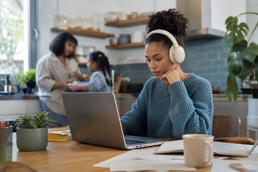 remote workers and students comparing noise canceling headphones for a kitchen table doubles as an office while conversations, traffic, and appliances compete for attention.