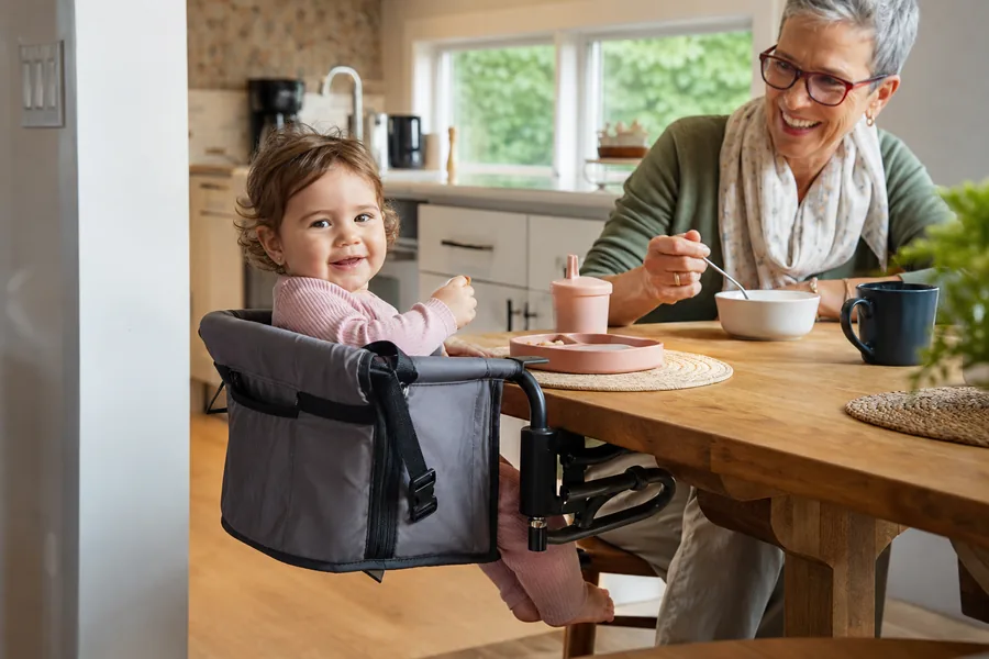 families on the move comparing portable travel high chair for meals happen at a grandparent’s table, a rental kitchen, and an occasional picnic table.