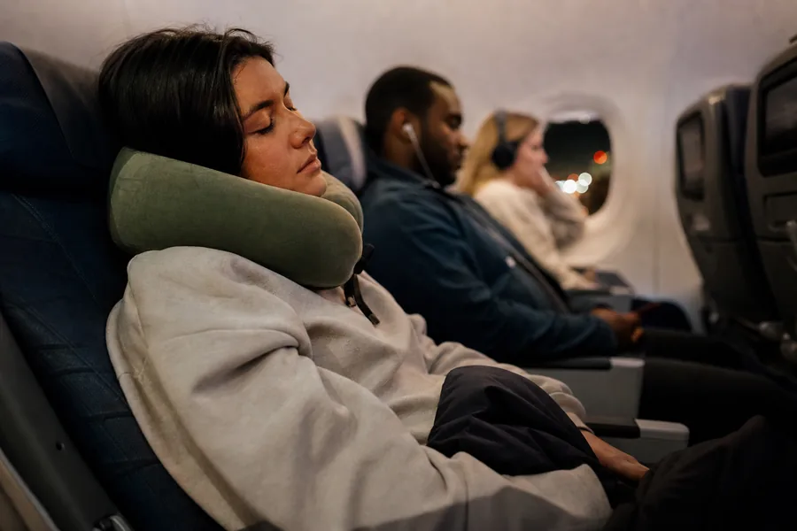 long-haul passengers comparing supportive travel neck pillow for a red-eye seat reclines only slightly and the window is not always available for support.