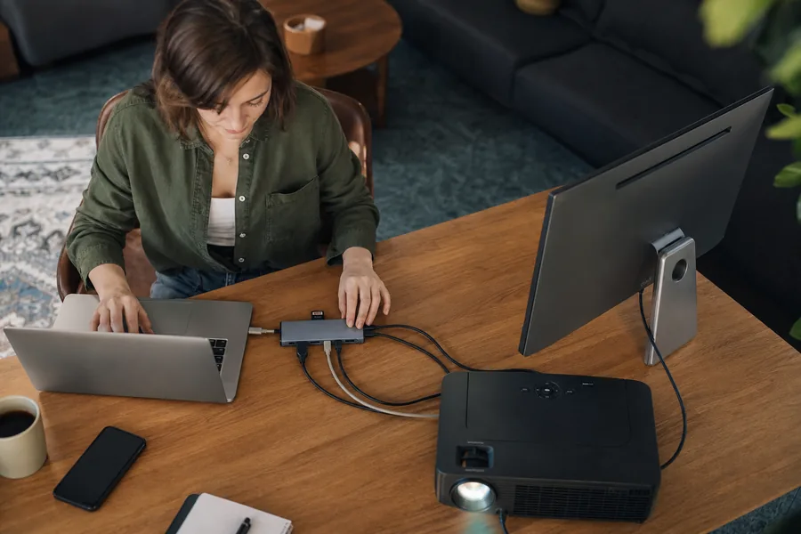 laptop-first workers comparing usb c hub multiport for one laptop has to connect to a monitor at home, a projector at work, and an SD card on the road.